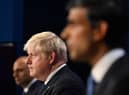Boris Johnson flanked by Sajid Javid and Rishi Sunak who have both resigned from the cabinet