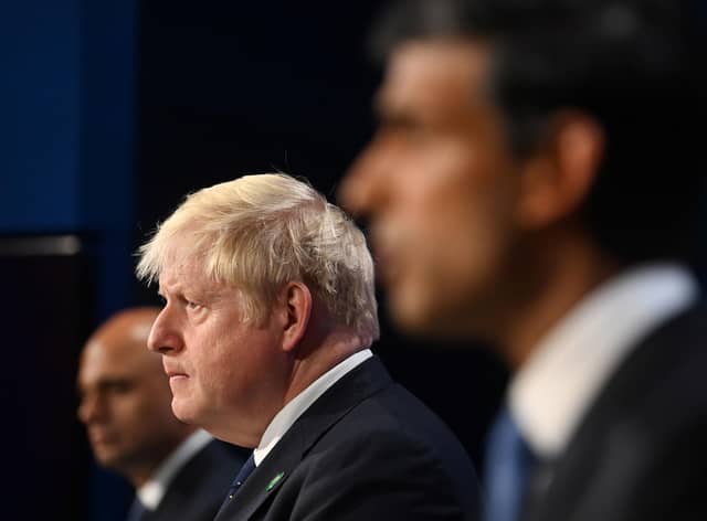 Boris Johnson flanked by Sajid Javid and Rishi Sunak who have both resigned from the cabinet