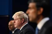 Boris Johnson flanked by Sajid Javid and Rishi Sunak who have both resigned from the cabinet