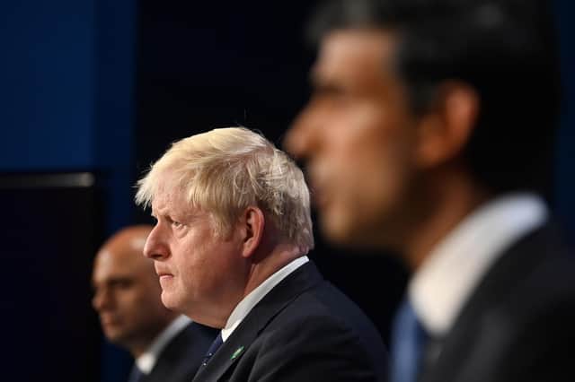 Boris Johnson flanked by Sajid Javid and Rishi Sunak who have both resigned from the cabinet