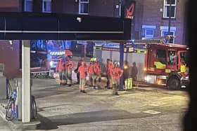 Emergency service personnel at a petrol station ear to where the bomb was found