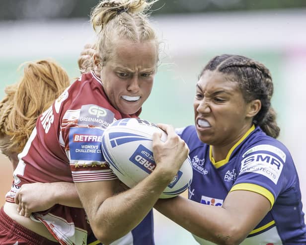 Wigan's Anna Davies is tackled by Leeds's Sophie Robinson