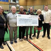 Douglas ward councillors Mary Callaghan, left, and Pat Draper and Matt Dawber, right, present the cheque to members of Robin Park Indoor Bowling Club