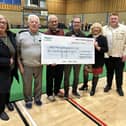 Douglas ward councillors Mary Callaghan, left, and Pat Draper and Matt Dawber, right, present the cheque to members of Robin Park Indoor Bowling Club