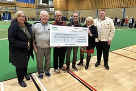 Douglas ward councillors Mary Callaghan, left, and Pat Draper and Matt Dawber, right, present the cheque to members of Robin Park Indoor Bowling Club