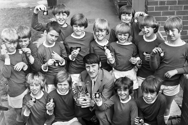 Derek Temple, former Everton, Preston North End and Wigan Athletic star presents the Greenhous Cup to Wigan and District Primary Schools champions, Standish St. Wilfrid's Primary School football team on Wednesday 17th of May 1972. Temple played for Latics in the early 1970s.