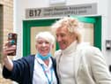 Sir Rod Stewart poses for photos with members of staff at the Princess Alexandra Hospital in Harlow, Essex