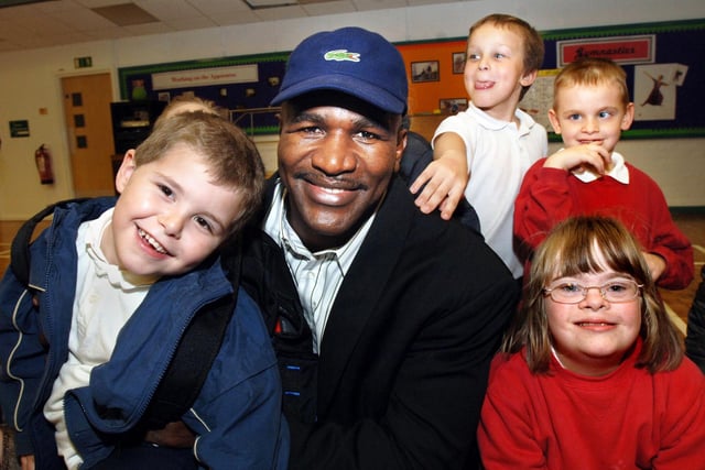 Famous boxer Evander Holyfield meets some of the younger pupils at Hope School during his visit.