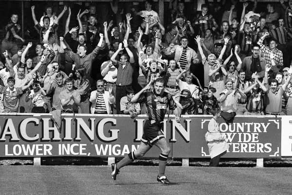 Wigan Athletic defender Paul Rennie peels away and sends the fans wild after opening the scoring in the 1-1 draw with Wycombe Wanderers in a 3rd division match at Springfield Park on Saturday 28th of August 1993.