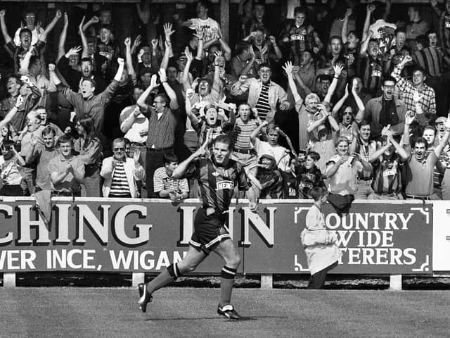 Wigan Athletic defender Paul Rennie peels away and sends the fans wild after opening the scoring in the 1-1 draw with Wycombe Wanderers in a 3rd division match at Springfield Park on Saturday 28th of August 1993.