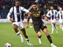 Josh Magennis hunts the ball during his lively cameo at West Brom