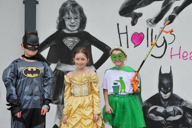 Holly Prince's sister Evie, centre, and classmates with the mural