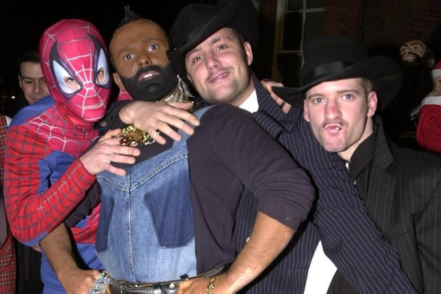 Spiderman, Mr T, and a pair of gangsters make up the fancy dress parade in King St Wigan on Boxing Day 2004.