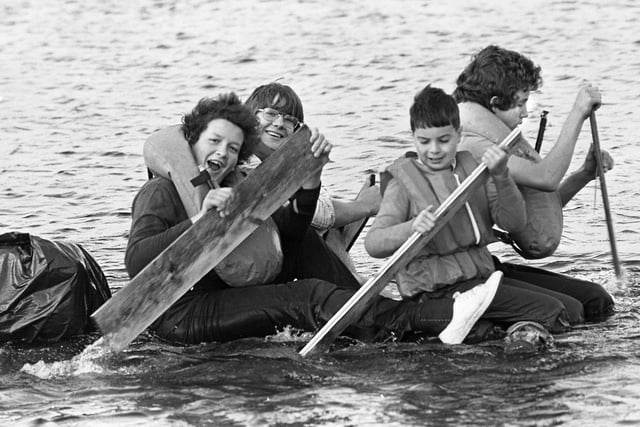 One of the more successful Wigan scout troops paddle their hand built raft on Orrell Reservoirs during one of the first raft racing events in October 1975. 