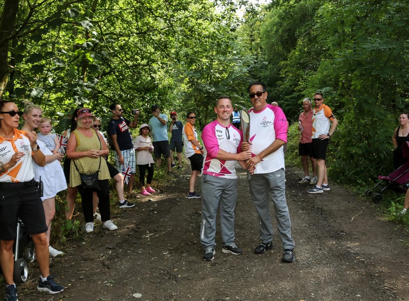Batonbearers Alex Winstanley and Nazir Afzal hold the Queen's baton