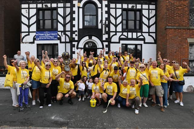 Nigel Brookwell and his team of supporters take a break at Real Crafty, Wigan