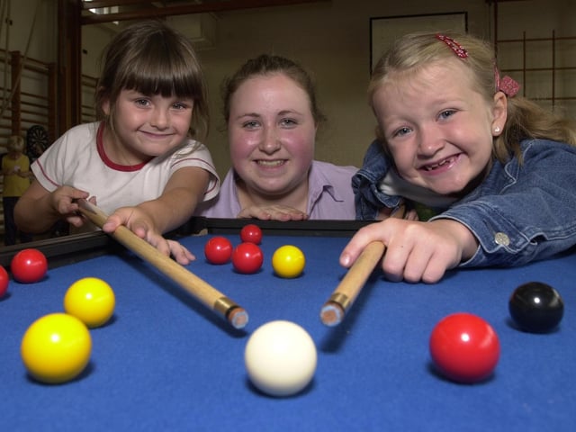 Jessica Miller, five, left, and Georgia Jackson, seven on cue at a summer play scheme held at Golborne High School with Wigan and Leigh College work experience student Stephanie Partington
