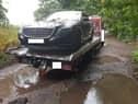 The Merc is put onto a low-loader by police after its discovery down a dirt track