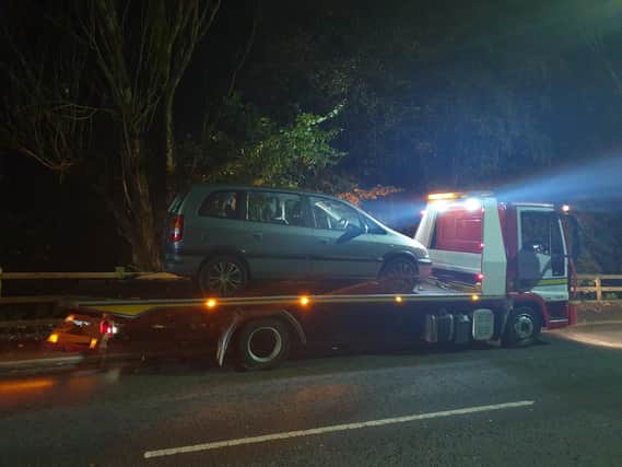 The uninsured car is put by police onto a low-loader in Abram