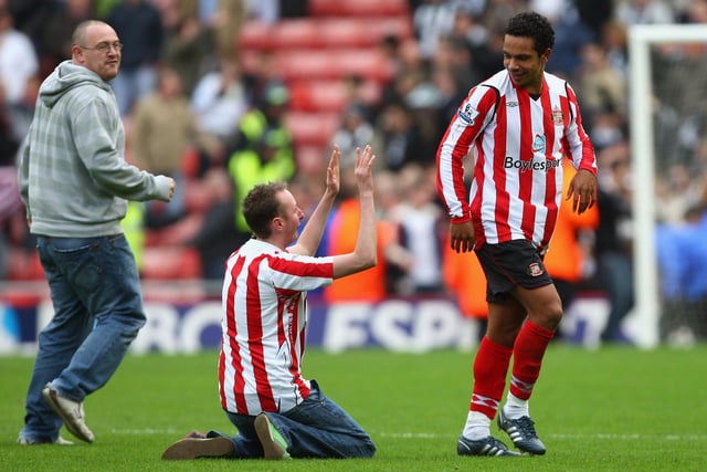 A Sunderland fan sinks to his knees in front of goalscorer Kieran Richardson of Sunderland at the end of the Premier League match between Sunderland and Newcastle United at the Stadium of Light on October 25, 2008.