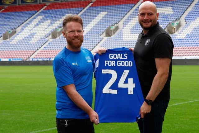Kevin Goodall (left, Goals for Good) and Gareth Nolan (Wigan Athletic) celebrate the app's launch