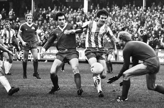 Wigan Athletic striker, Peter Houghton, battles for the ball against Hereford United during the Division 4 match at Springfield Park on Saturday 7th of November 1981.
The match was a 1-1 draw with Graham Barrow getting the Latic's goal.