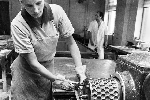 The mint balls begin to take shape feeding onto a drop roller at the Santus factory in Dorning Street, Wigan, in July 1977.