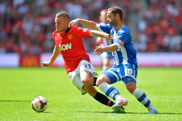 Tom Cleverley locks horns with Latics' Shaun Maloney during the 2013 Charity Shield at Wembley