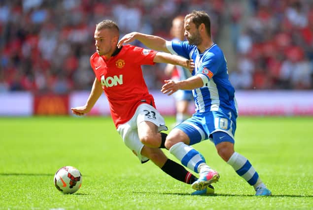 Tom Cleverley locks horns with Latics' Shaun Maloney during the 2013 Charity Shield at Wembley