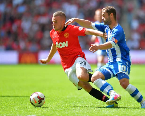 Tom Cleverley locks horns with Latics' Shaun Maloney during the 2013 Charity Shield at Wembley