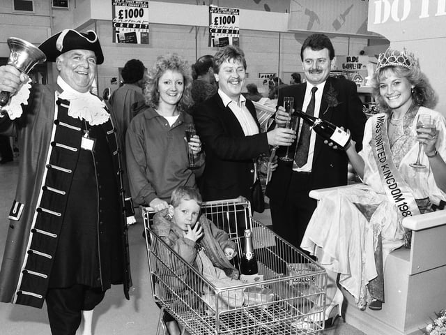 Miss United Kingdom, Karen Mellor, pours champagne for competition winners Tom and Wendy Ratcliffe from Marus Bridge after officially opening the new Do It All store on Chapel Lane, Wigan, on Friday 29th of April 1988. The couple won a weekend in Paris in a lucky gift voucher draw and are pictured with son Kevin and store manager Larry Marlow.