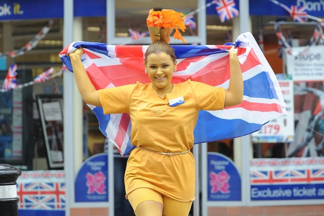 Olympic Torch Relay, Wigan Town Centre:  Kelly Fagan, from Thomas Cook, dressed as the Olympic torch