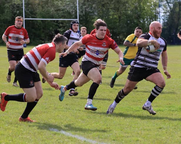 Action from Wigan's semi-final victory at Harbury of Warwickshire