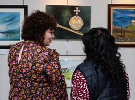 Visitors view the artwork on display