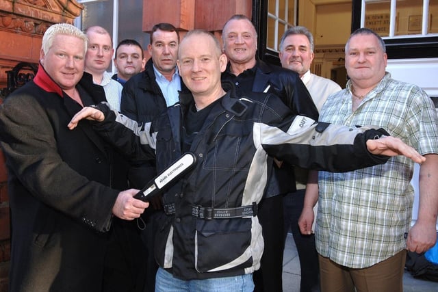 Andy Boardman, general manager of MYL Security, demonstrates one of the metal detectors that will be used at Wigan's pubs and clubs on town centre manager Mike Matthews. Looking on are Jon Ambrose, chairman of Wigan Pubwatch, Peter Midgley, from Maxim's, Ian Liptrot, licencing officer for GM Police, MYL Security owner Mick Lyons, and Ian Robins and Keith Baldwin, from Bentley's Bar.