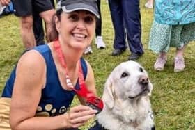 Amanda Hough with her Great North Run medal as she met a guide dog after the race