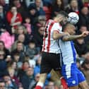 Josh Magennis competes for the ball