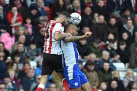 Josh Magennis competes for the ball
