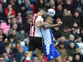 Josh Magennis competes for the ball