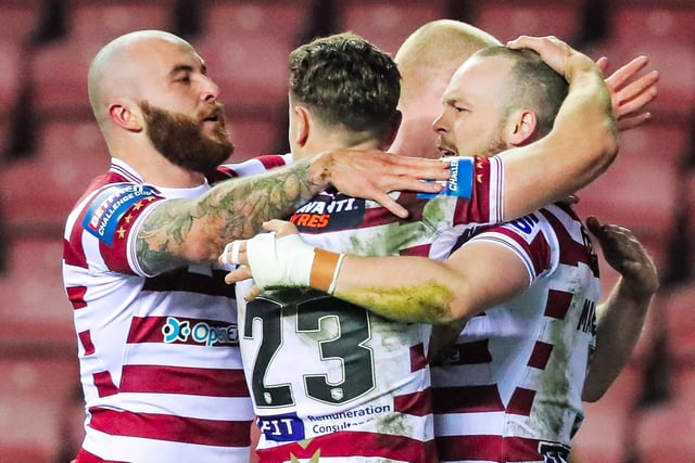 The Wigan players celebrate a 20-0 victory over Paul Rowley's side.