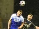 Charlie Hughes wins another header against Coventry