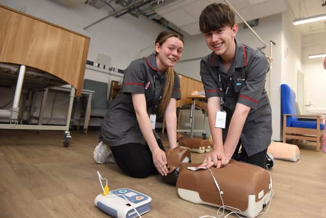 Students Kelsey Heaton and Johnathan Quinn give demonstrations of the T-level health course