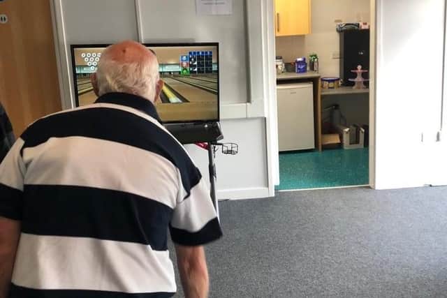 A member of the Generational Gamers Group plays a game of bowling on Wii Sports