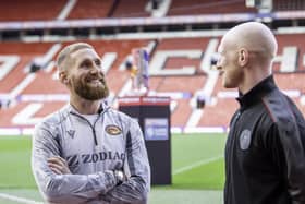 Catalans Sam Tomkins talks to old team mate, Wigan's Liam Farrell inside Old Trafford on Thursday