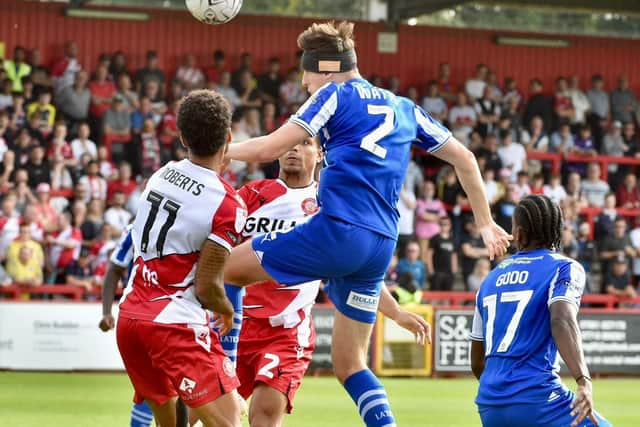 Kell Watts heads for goal for Latics at Stevenage