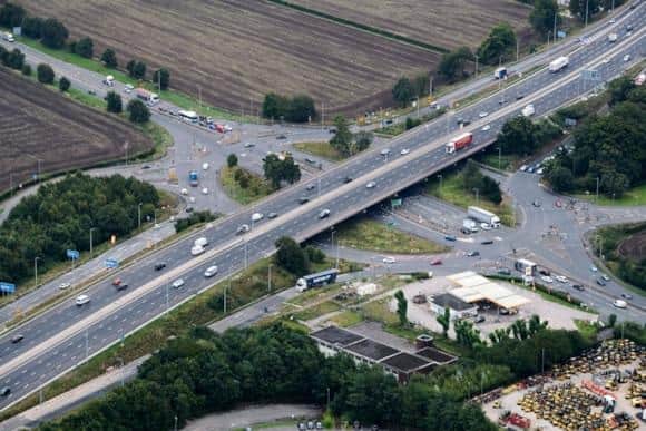 Aerial image of the M6 running above busy Haydock Island and the A580 East Lancashire Road