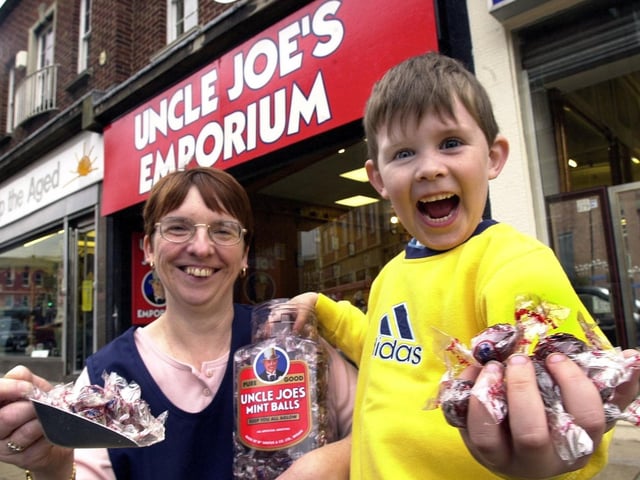 Keeping all aglow at Uncle Joe's Emporium is 5 year old Brad Roby served by Julie Quilliam.