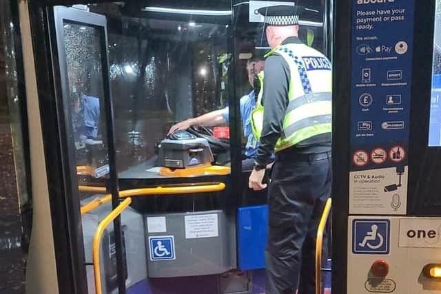 A police officer chats to a Wigan bus driver