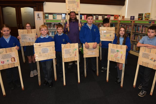 Local author and poet Ray Douglasand Year Six pupils from St Thomas's CE primary school, Ashton-in-Makerfield.