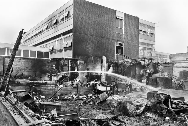 Firemen damp down after a fire which gutted classrooms at St. Peter's Catholic High School in Orrell on Sunday 16th of December 1990.